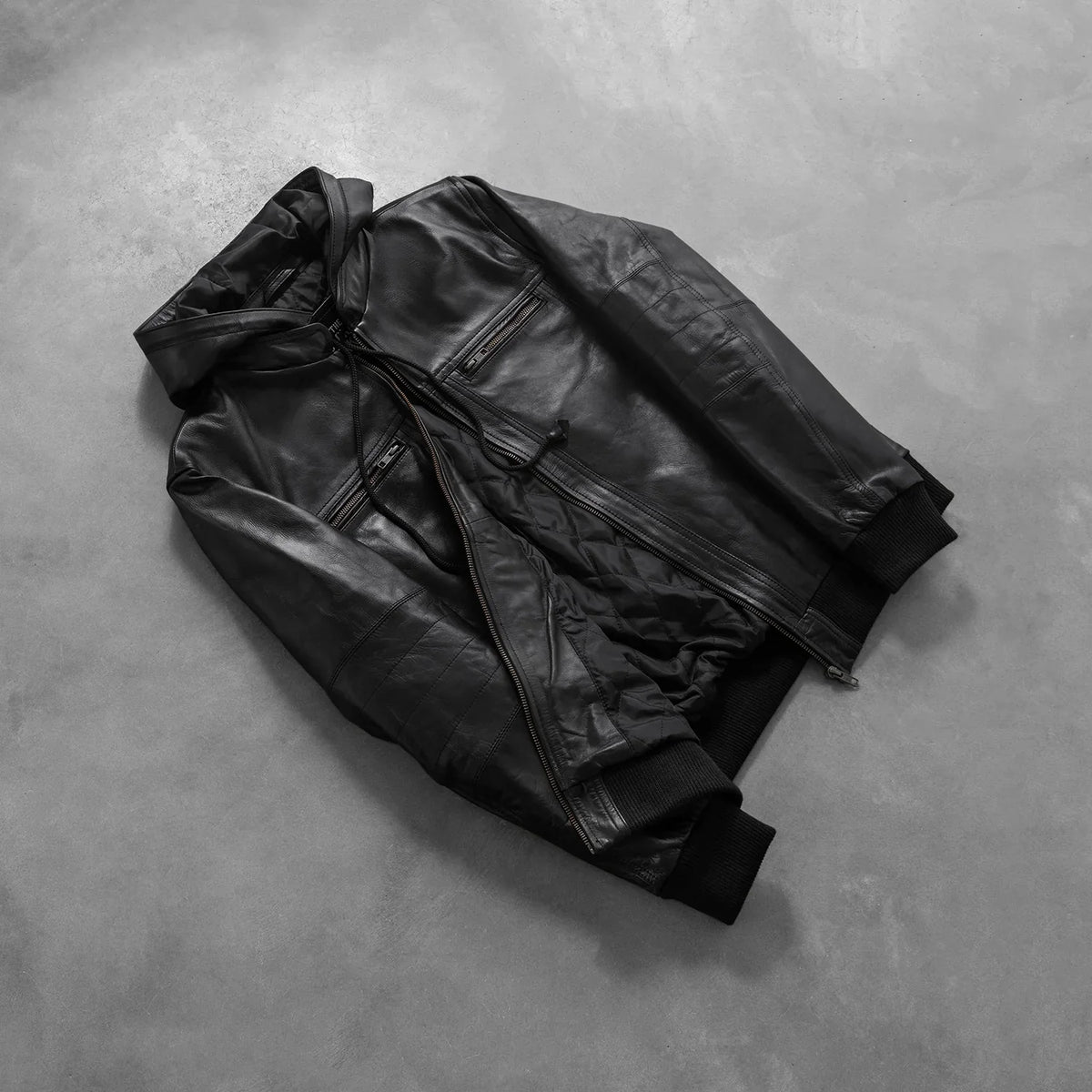 
Styled Fit Perspective of Bouncer Biz Black Leather Hooded Bomber Jacket on Model - Natural Daylight Drape